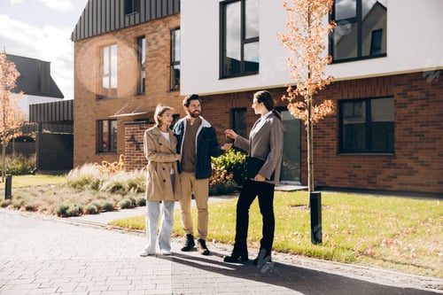 Preview: Confident real estate agent handing keys to happy homeowner couple