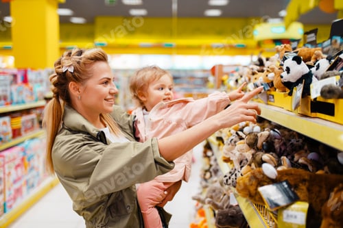 Preview: Mother with her girl choosing toys in kids store