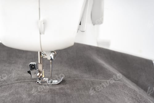 Preview: Modern Sewing Machine Presser Foot With Gray Fabric And Thread, Closeup