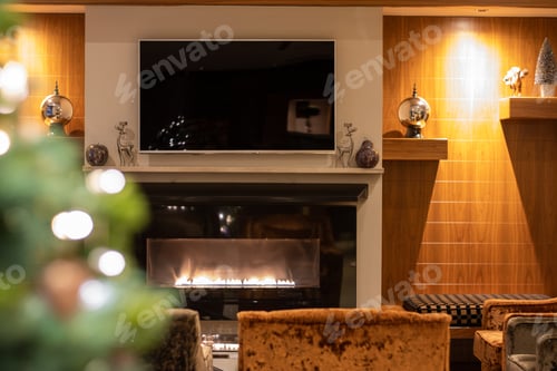 Preview: Christmas Fireplace With A Blurred Christmas Tree In Foreground.