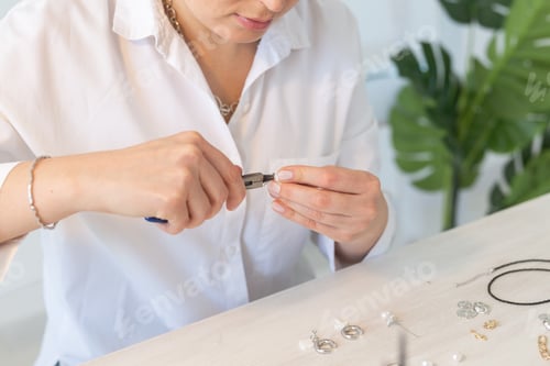 Preview: Professional jewelry designer making handmade jewelry in studio workshop close up. Fashion