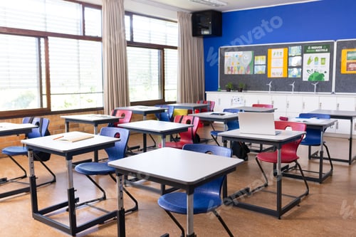 Preview: Classroom with Desks and Chairs in Bright Sunlight