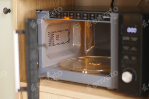 Preview: Microwave oven on a kitchen counter with an open door