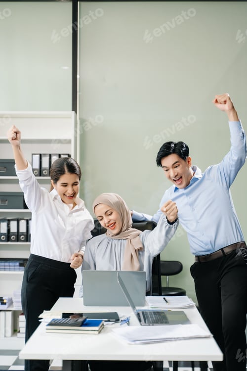 Preview: Happy businesspeople while collaborating on a new project in an office.