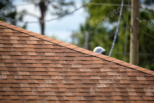 Preview: Closeup of house roof top covered with asphalt or bitumen shingles. Waterproofing of new building