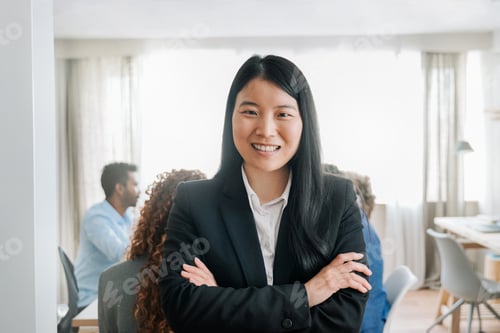 Preview: Asian business woman smile at camera inside office workplace. Focus on chinese female worker face