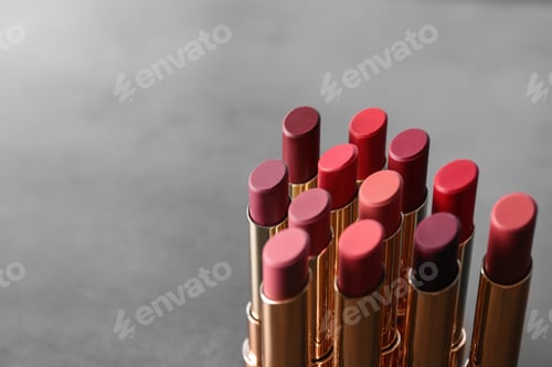 Preview: Set of bright lipsticks on grey background. Space for text