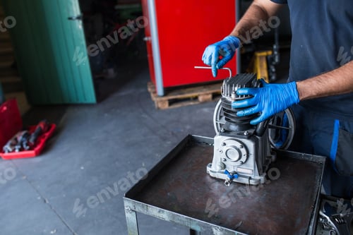 Preview: Mechanic fixing a compressor engine