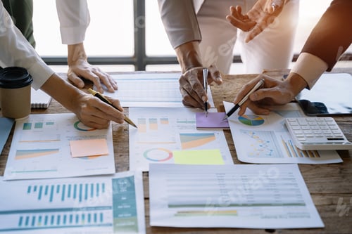 Preview: Business Team Analyzes Charts in an Urban Office