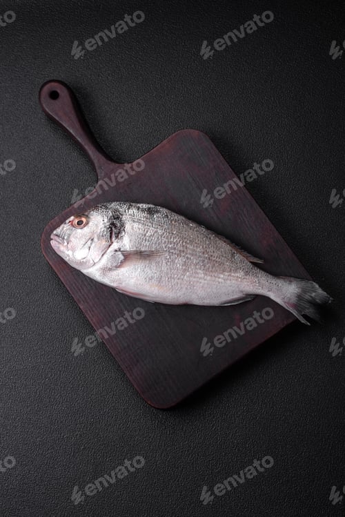 Preview: Fresh raw dorada fish with salt, spices and herbs