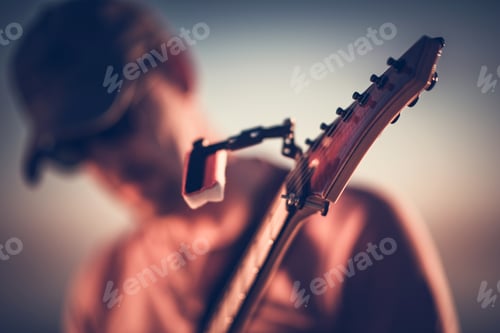 Preview: Blurred musician with guitar headstock close up