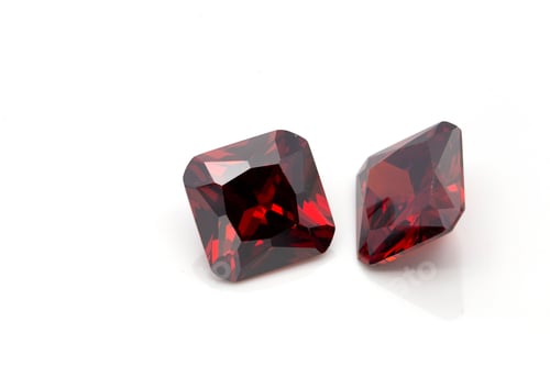 Preview: Closeup of red ruby gemstones isolated on a white background