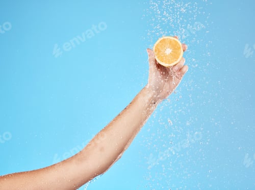 Preview: Lemon, water and hand of woman with fruit for health, beauty and wellness against blue mockup studi