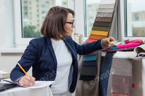 Preview: Woman textile interior designer working with fabric samples, hangers