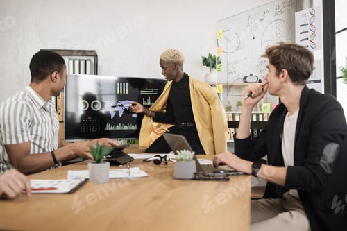 Preview: Multiethnic male brokers spending time at office for making strategy of successful business project.
