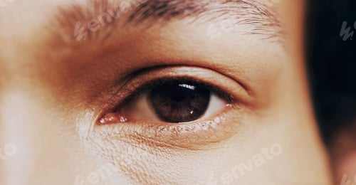 Preview: Look at defeat right in the eyes. Closeup shot of man opening his eyes against a dark background.