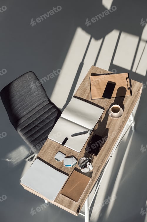 Preview: top view of notebooks, smartphone and cup of coffee on table at modern workplace