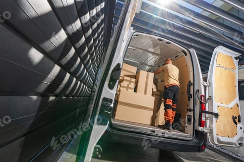 Preview: Courier Loading Cargo Boxes Into Van For Delivery