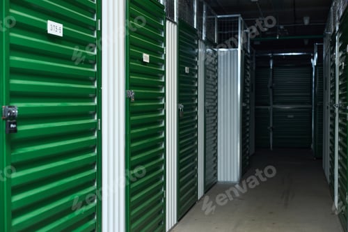 Preview: Row of Green Storage Unit Doors in Self Storage Facility Corridor