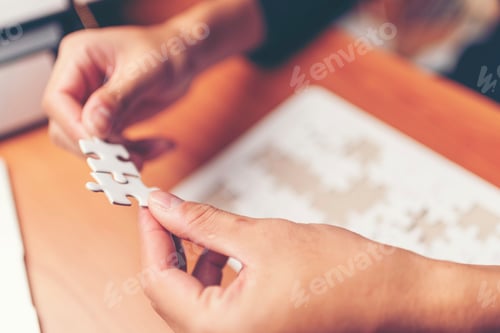 Preview: Man hands connecting couple puzzle piece in office. Business solutions, target, successful