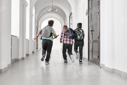Preview: Group of schoolboys with school backpacks running