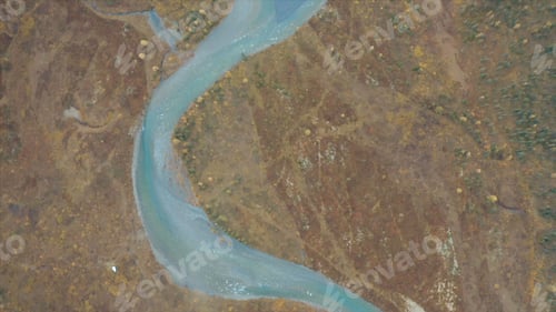 Preview: Top view of winding blue river. Clip. Beautiful blue river flows in deserted area. Blue river with