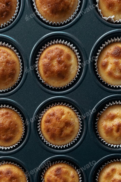 Preview: Top view and close up group homemade pumpkin muffins in iron mold. Autumn dessert. Halloween treats.