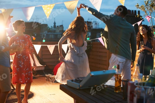 Preview: Friends dancing at early evening party