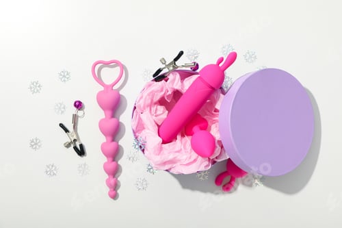 Preview: Sex toy with New Year's decor on a light background.