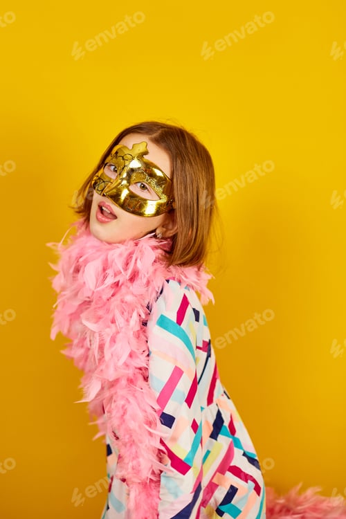 Preview: A joyful teenager girl wearing a colorful Brazil carnival mask
