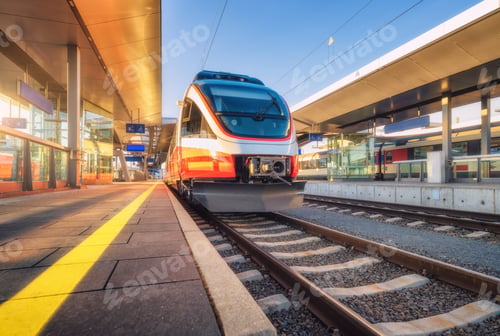 Preview: High speed train on the modern railway station at sunset