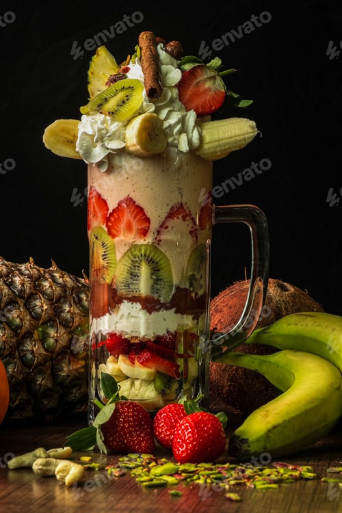 Preview: A pitcher of fruit salad and cocktails on a wooden floor