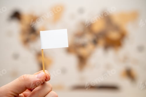 Preview: White flag with copy space in man hands with world map on the background