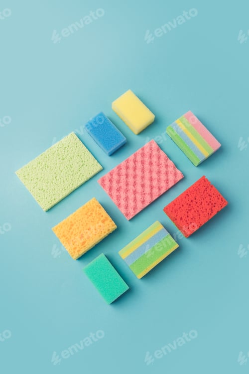 Preview: top view of colorful washing sponges, isolated on blue