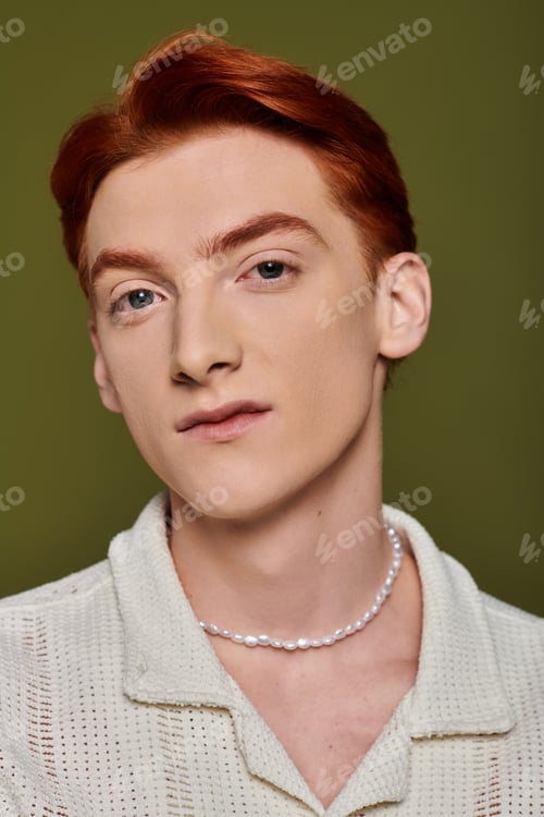 Preview: Young man with striking red hair expressing deep emotions in a creative portrait setting