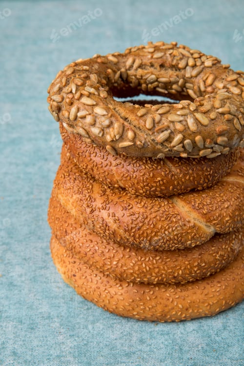 Preview: side view of bagels on blue background with copy space