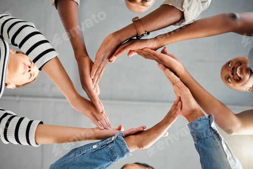 Preview: Group of businesspeople forming a circle with their hands in an office at work. Colleagues having f