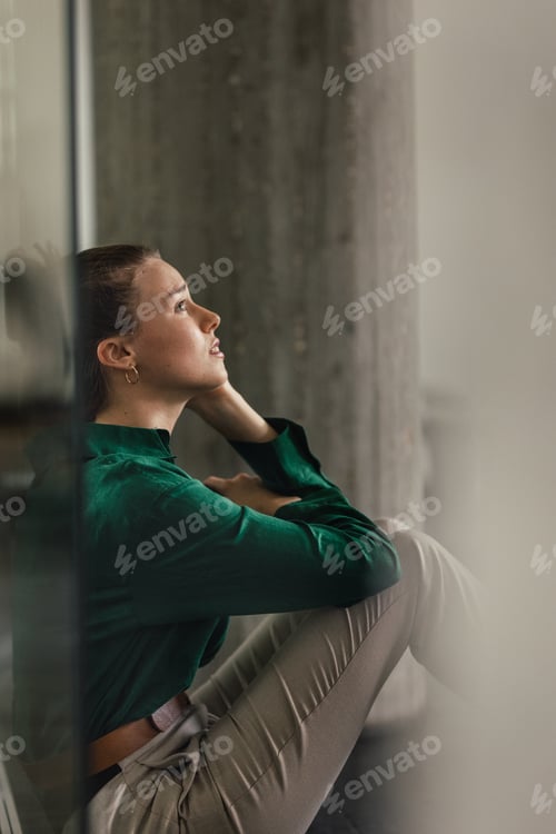 Preview: Young sad woman in office, having problem.
