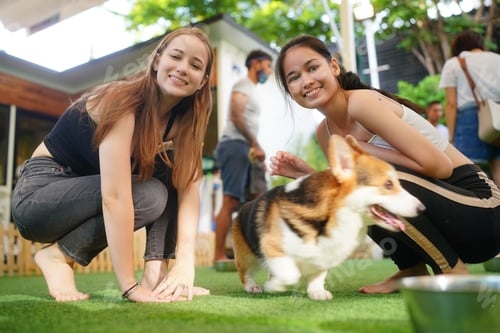 Preview: Lovely young woman playing with her dog