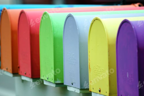 Preview: Array of multi-colored post boxes stacked on a ledge in a neat formation
