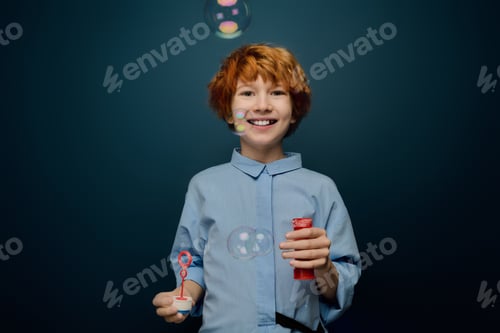 Preview: Joyful boy creates bubbles, capturing childhood magic in a playful moment indoors