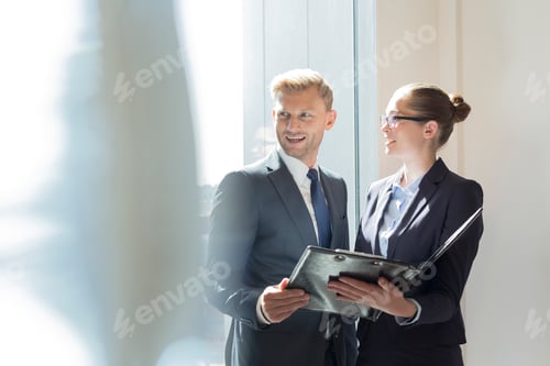 Preview: Businessman and businesswoman preparing for meeting