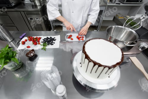 Preview: Pastry chef cuts strawberries to decorate the cake.