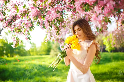 Preview: Spring Style. Beautiful Young Brunette Woman In Nice Spring Dress With A Bouquet Of Tulips.