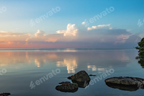 Preview: A beautiful early morning on the bay with still water and sea rocks.