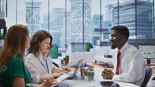 Preview: Job candidate sits across from interviewers team in high end office
