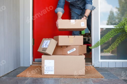 Preview: Man picking up delivered packages from the porch