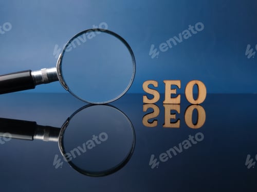 Preview: Wooden word SEO and magnifying glass on a black acrylic board