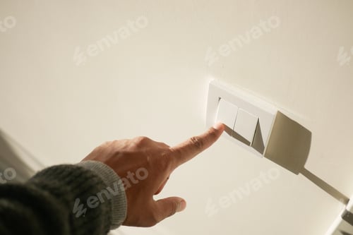 Preview: A finger turning on lighting switch .