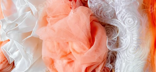 Preview: Top view abstract background of crumpled peach and white chiffon.